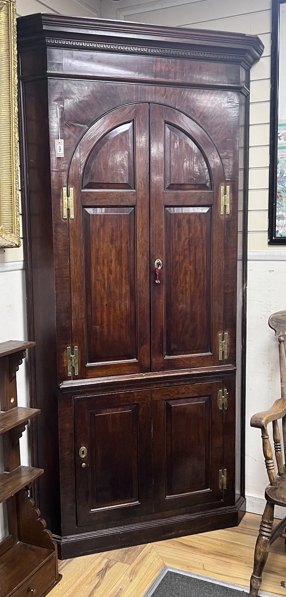 A George III mahogany standing corner cabinet, width 110cm, depth 56cm, height 228cm